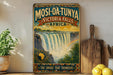 A vintage-style poster advertising the Masi-O-O-Tunya Victoria Falls in Africa, featuring a waterfall and a rainbow.