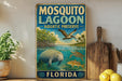 A vintage-style sign for Mosquito Lagoon Aquatic Preserve in Florida, featuring illustrations of a manatee, a pelican, and a turtle swimming in the water.