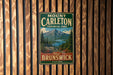 A vintage metal sign for Mount Carleton Provincial Park in New Brunswick, Canada, featuring a scenic mountain landscape.