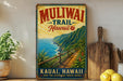 a vintage-style metal sign for Muliwaik Trail in Kauai, Hawaii, with a scenic mountain landscape and a wooden fence.