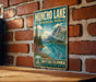 A vintage-style metal sign for Muncho Lake, a scenic park in British Columbia, Canada.