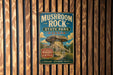 A vintage metal sign for Mushroom Rock State Park in Kansas, featuring an illustration of a mushroom formation and text promoting the park's natural beauty and wonder.