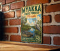 A vintage-style metal sign for the Myakka State Forest in Florida, featuring an illustration of a bird and a crocodile in a natural setting.
