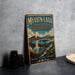 A vintage travel poster advertising Iceland, featuring a scenic landscape with a lake, mountains, and steam vents, is displayed on a wall next to some camera equipment.