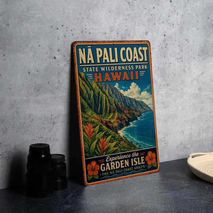 A vintage-style metal sign advertising the Na Pali Coast State Wilderness Park in Hawaii, featuring a scenic mountain landscape with a beach and ocean.