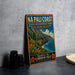 A vintage-style metal sign advertising the Na Pali Coast State Wilderness Park in Hawaii, featuring a scenic mountain landscape with a beach and ocean.