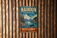 A vintage metal sign for NaiKoon Provincial Park in British Columbia, Canada, featuring a scenic landscape with mountains, trees, and a whale in the water.