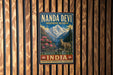 A vintage-style metal sign for the Nanda Devi Biosphere Reserve in Western Himalaya, India, featuring a mountain landscape with a goat and pink flowers.