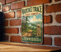 A vintage metal sign for the Natchéz Trace State Forest in Tennessee, featuring a scenic illustration of a forest trail and a horse.