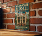 A vintage-style metal sign for the Nathaniel Russell House in Charleston, South Carolina, mounted on a brick wall.