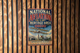 A vintage metal sign for the National Aviation Heritage Area in Ohio, featuring an illustration of a biplane and text promoting aviation heritage.