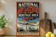 a vintage-style sign for the National Aviation Heritage Area in Ohio, with a biplane illustration and a barn in the background.