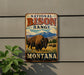 A vintage metal sign for the National Bison Range in Montana, featuring an illustration of a bison in a grassy field with mountains in the background.