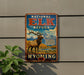 A vintage-style metal sign for the National Elk Refuge in Wyoming, featuring an illustration of a majestic elk standing in a scenic landscape with mountains in the background.