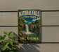 A vintage-style metal sign for Natural Falls State Park in Oklahoma, featuring a waterfall and lush greenery.
