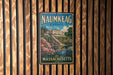 A vintage metal sign for Naumkeag Estate in Massachusetts, featuring a scenic illustration of the estate surrounded by a garden and a pond.