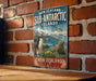 A vintage-style sign for the Sub-Antarctic Islands in New Zealand, featuring a penguin and a seal in a scenic landscape.