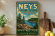 A vintage-style sign for "Nees Provincial Park - Ontario" featuring a scenic landscape with pine trees, a lake, and mountains.