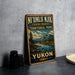 A vintage-style metal sign advertising Yukon, featuring a scenic mountain landscape with a river and pine trees.