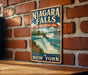 A vintage-style sign for Niagara Falls, the National Heritage Area in New York, is displayed on a brick wall.
