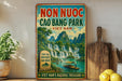 a vintage-style poster advertising the Non Nuoc Cào Bang Park in Vietnam, with a scenic image of the park and a waterfall.