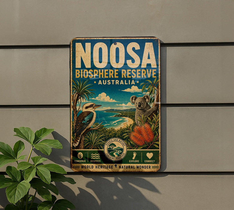 a vintage-style sign for the Noosa Bioscape Reserve in Australia, with a koala and a bird depicted on the sign.