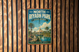 A vintage-style metal sign for North Riyadh Park in Saudi Arabia, featuring a scenic image of palm trees and a river.