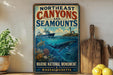 a vintage-style sign for the Northeast Canyon and Seamounts, with a marine theme, surrounded by a potted plant, a wooden cutting board, and some lemons.