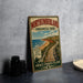 A vintage-style sign for Northumberland Provincial Park, featuring a scenic beach and boardwalk illustration, is displayed on a gray wall.