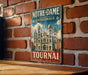 A vintage metal sign with the text "NOTRE-DAME CATEDRALE TOURNAI BELGIQUE" is displayed on a brick wall.