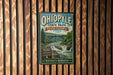 A vintage-style metal sign for Ohio State Park in Pennsylvania, featuring a scenic image of a waterfall and forest.