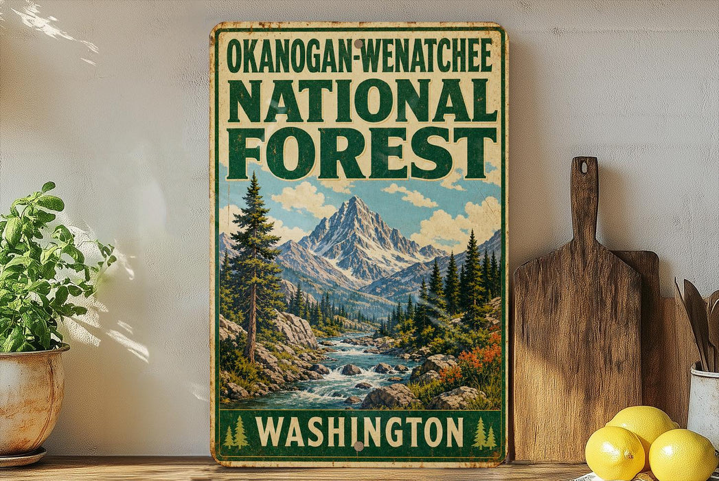 A vintage-style sign for the Okanogan-Wenatchee National Forest in Washington, featuring a mountain landscape with a river and pine trees.
