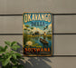 A vintage-style metal sign with the text "OKAVANGO DELTA Botswana" and an illustration of a man in a boat on a river surrounded by wildlife, including elephants and a bird.