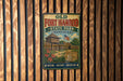 A vintage-style metal sign for Old Fort Harrod State Park in Kentucky, featuring a wooden cabin and a flag, mounted on a wooden wall.