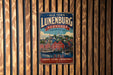 A vintage-style metal sign for "Old Town Lunenburg, Canada" is displayed on a wooden wall.