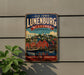 A vintage-style metal sign for the Old Town of Lunenburg, Canada, featuring a colorful illustration of the town's buildings and harbor.