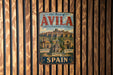A vintage metal sign with the text "Old Town of AVILA" and "With its Extra-Marros Churches" is displayed on a wooden wall.