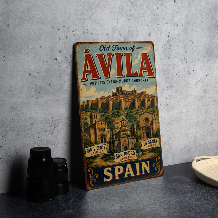 A vintage metal sign advertising the Old Town of Avila, Spain, with its extra muros churches, is displayed on a table.