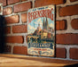 A vintage metal sign displaying the text "OLD TOWN OF REGENSBURG" and "STADTAMHOF GERMANY" is mounted on a brick wall.
