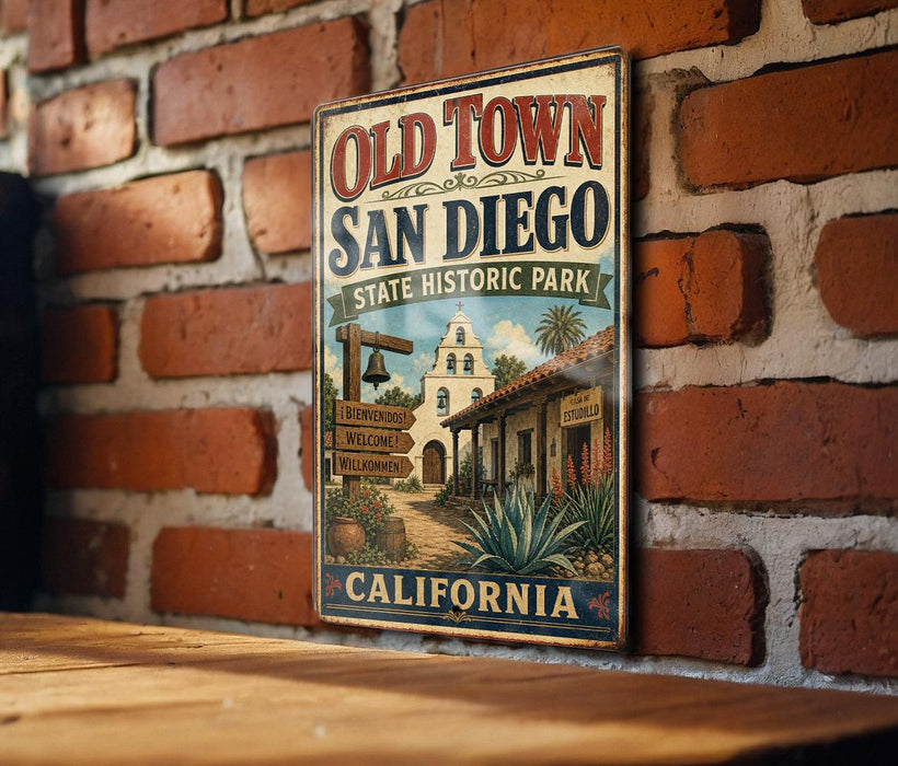 A vintage-style metal sign for Old Town San Diego, California, featuring a brick wall and a sign with a welcoming message.