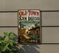A vintage-style metal sign for Old Town San Diego State Historic Park, featuring a historical building and a welcoming sign.