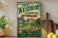 a vintage-style sign for Old Westbury Gardens in New York, with a large illustration of a well-manicured garden and a large house in the background. The sign is displayed on a wooden shelf, surrounded by various kitchen utensils and decorative items, such as a potted plant, a wooden cutting board, and a bowl of fruit.