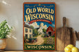 a vintage-style metal sign for "Old World Wisconsin" with a picture of a farm and a barn, placed on a shelf next to a wooden cutting board and some lemons.