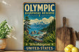 a vintage-style sign for the Olympic Biosphere Reserve in Washington, United States, with a scenic landscape depicting mountains, forests, and a body of water.