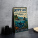 a vintage-style metal sign for the Olympic Coast National Marine Sanctuary in Washington, with a depiction of marine life and a mountainous landscape.