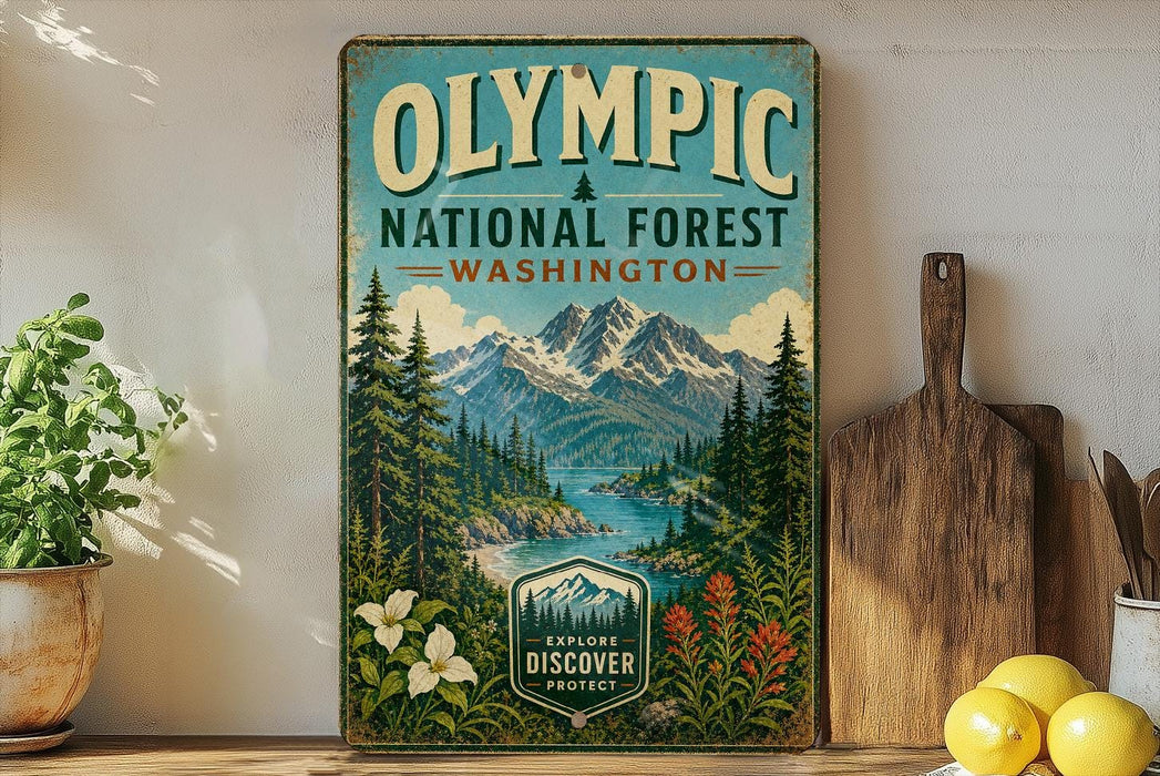 a vintage-style sign for the Olympic National Forest in Washington, with a mountain landscape and a river in the background. The sign is displayed on a shelf next to a wooden cutting board and some potted plants.