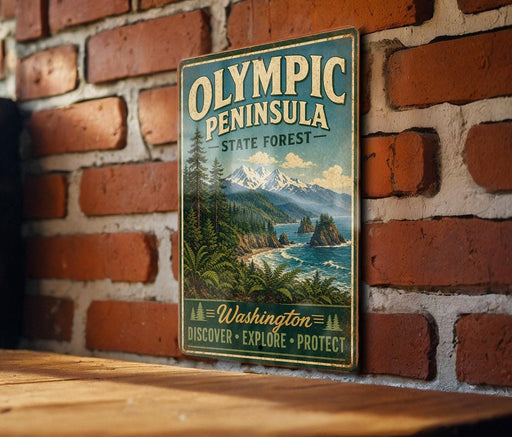 A vintage-style metal sign for the Olympic Peninsula State Forest, featuring a scenic landscape with mountains, pine trees, and a body of water.