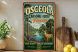 A vintage-style metal sign for the Osceola National Forest in Florida, featuring an illustration of a deer, all set against a lush, tropical forest backdrop.