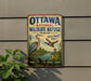 A vintage-style metal sign for the Ottawa National Wildlife Refuge in Ohio, featuring illustrations of birds and a scenic landscape.