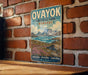 a vintage-style sign for Oayoyok, a famous hiking trail in Nunavut, Canada.